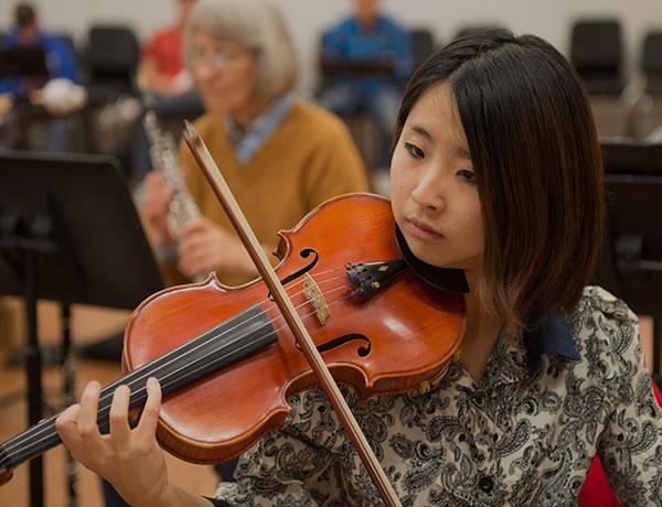 A woman playing the viola.